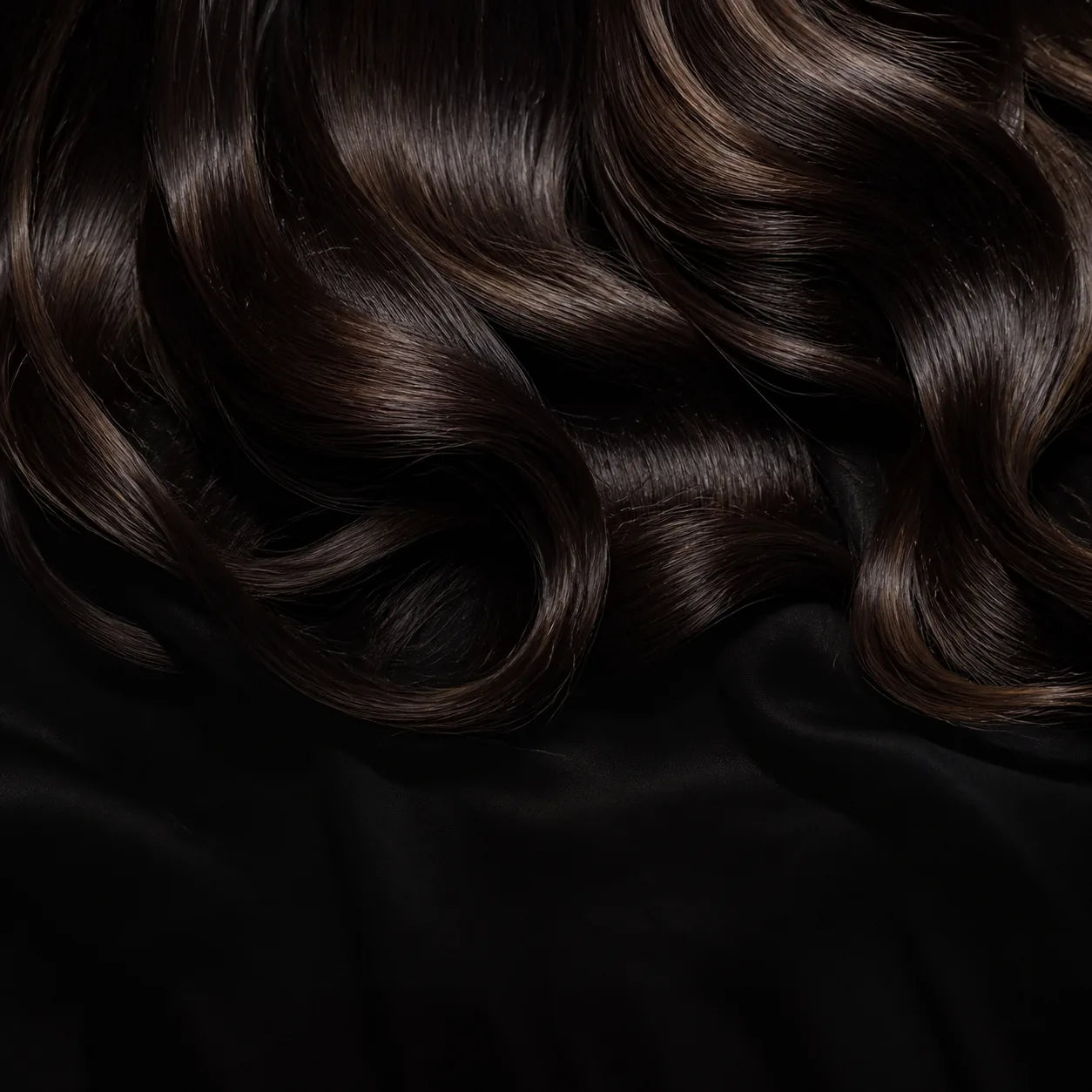 Close detail of the satin-finish curling set against softly waved hair